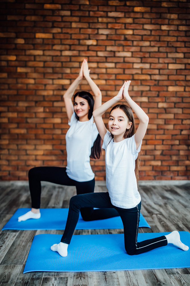 Kids performing partner yoga poses