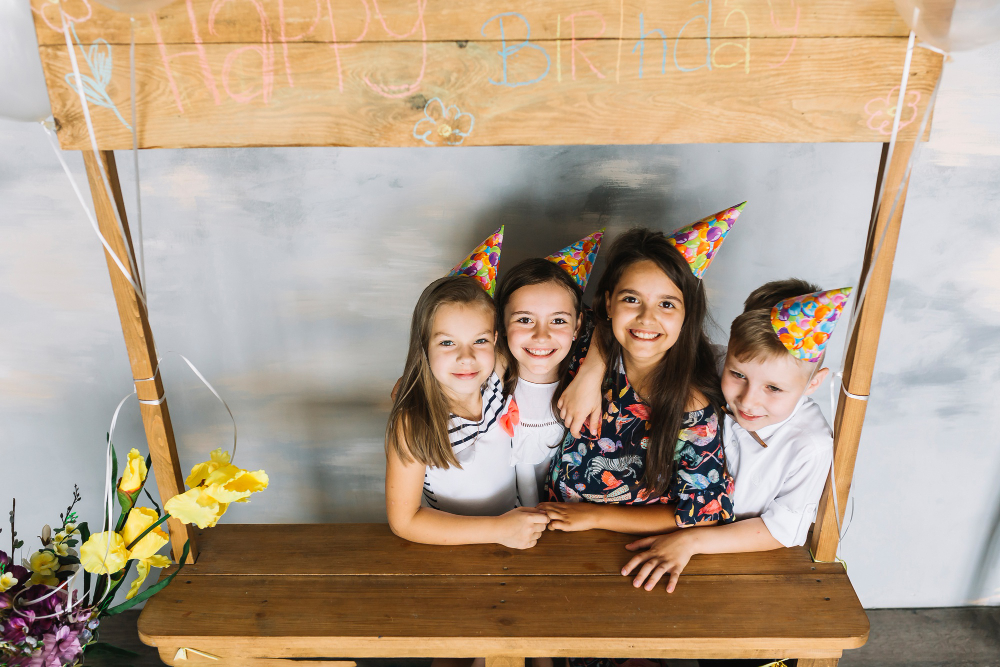 Childhood photo of siblings together or a family photo during a birthday celebration.